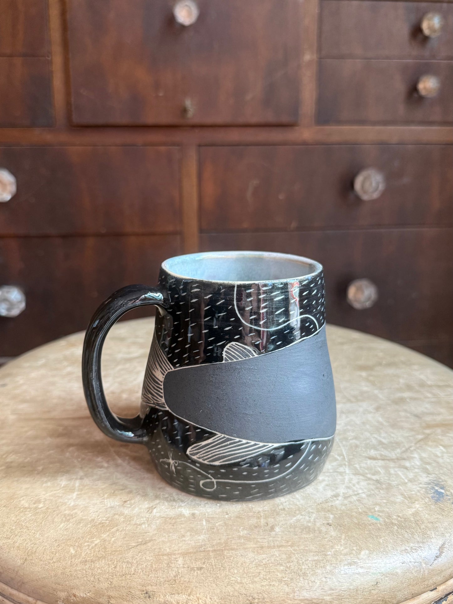 Brother fish black on black mug