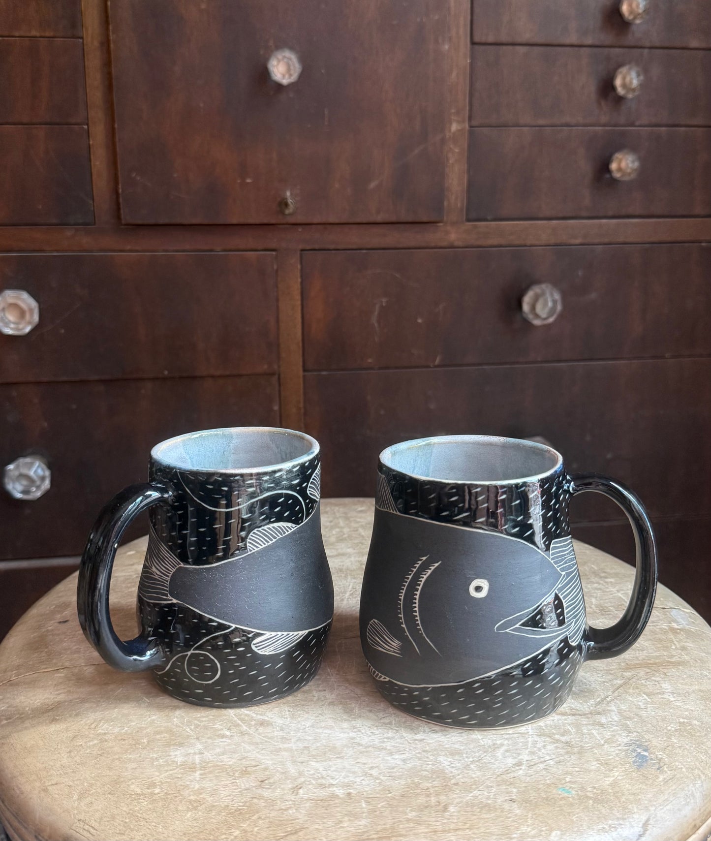 Brother fish black on black mug