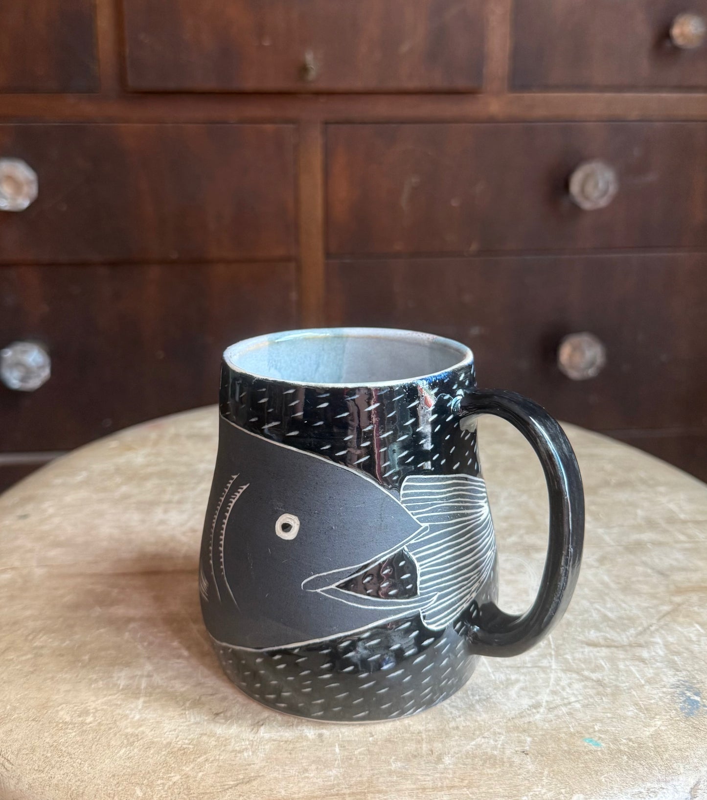 Brother fish black on black mug